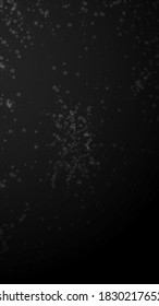 Magic stars Christmas background. Subtle flying snow flakes and stars on black background. Adorable winter silver snowflake overlay template. Superb vertical illustration.