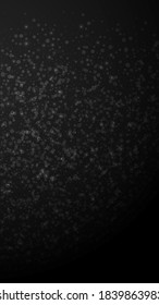 Magic stars Christmas background. Subtle flying snow flakes and stars on black background. Amusing winter silver snowflake overlay template. Exotic vertical illustration.