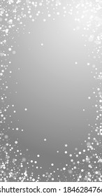 Magic stars Christmas background. Subtle flying snow flakes and stars on grey background. Actual winter silver snowflake overlay template. Pleasant vertical illustration.