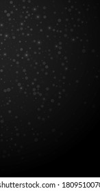 Magic stars random Christmas background. Subtle flying snow flakes and stars on black background. Amusing winter silver snowflake overlay template. Juicy vertical illustration.