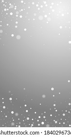 Magic stars random Christmas background. Subtle flying snow flakes and stars on grey background. Alluring winter silver snowflake overlay template. Nice vertical illustration.