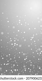 Magic stars random Christmas background. Subtle flying snow flakes and stars on grey background. Appealing winter silver snowflake overlay template. Creative vertical illustration.