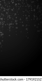 Magic stars sparse Christmas background. Subtle flying snow flakes and stars on black background. Amazing winter silver snowflake overlay template. Indelible vertical illustration.