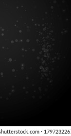 Magic stars sparse Christmas background. Subtle flying snow flakes and stars on black background. Adorable winter silver snowflake overlay template. Perfect vertical illustration.