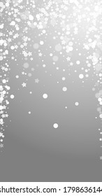 Magic stars sparse Christmas background. Subtle flying snow flakes and stars on grey background. Alluring winter silver snowflake overlay template. Delightful vertical illustration.