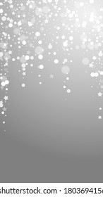 Magic stars sparse Christmas background. Subtle flying snow flakes and stars on grey background. Amazing winter silver snowflake overlay template. Juicy vertical illustration.