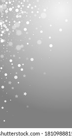 Magic stars sparse Christmas background. Subtle flying snow flakes and stars on grey background. Adorable winter silver snowflake overlay template. Imaginative vertical illustration.