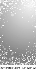 Magic stars sparse Christmas background. Subtle flying snow flakes and stars on grey background. Admirable winter silver snowflake overlay template. Fetching vertical illustration.