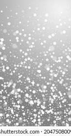Magic stars sparse Christmas background. Subtle flying snow flakes and stars on grey background. Appealing winter silver snowflake overlay template. Dazzling vertical illustration.