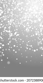 Magic stars sparse Christmas background. Subtle flying snow flakes and stars on grey background. Amazing winter silver snowflake overlay template. Exotic vertical illustration.