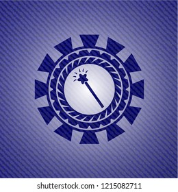 magic stick icon inside badge with denim texture