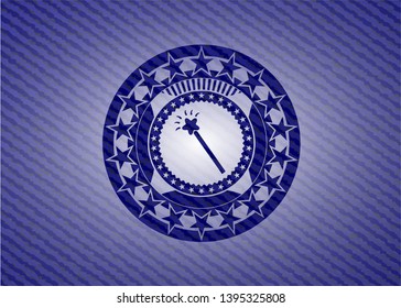 magic stick icon inside badge with denim texture