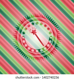 magic stick icon inside christmas emblem.
