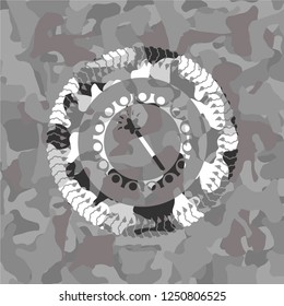 magic stick icon inside grey camouflaged emblem