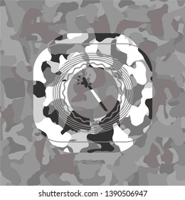 magic stick icon inside grey camouflage emblem