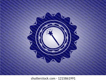 magic stick icon inside jean or denim emblem or badge background