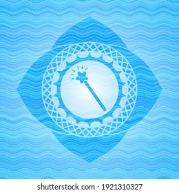 magic stick icon inside light blue water emblem. 