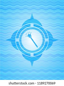 magic stick icon inside water concept badge background.