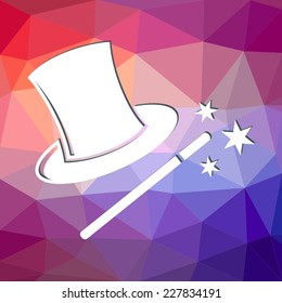Magic wand and hat on colorful triangle background