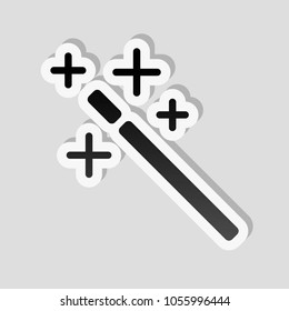 magic wand. simple silhouette. Sticker style with white border and simple shadow on gray background