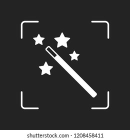 magic wand with stars. simple silhouette. White object in camera autofocus on dark background