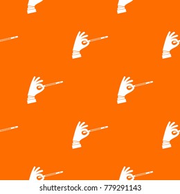 Magician hand with a magic wand pattern repeat seamless in orange color for any design. Vector geometric illustration