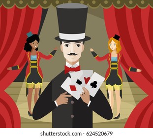 magician with magic trick poker cards on theater stage with assistants