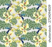 A magnificent pattern with birds of paradise and orchids.Vector seamless pattern with colorful birds of paradise and yellow orchids on palm leaves.