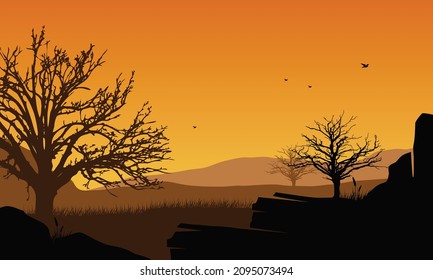 Magnificent view of the silhouetted mountains with dry trees from the countryside at sunset in the evening. Vector illustration of a city