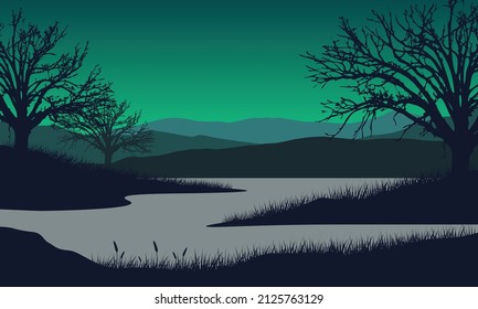 Magnificent views of mountains and lakes from the countryside with silhouettes of pine trees around