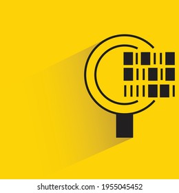 magnifier and bar code with shadow on yellow background