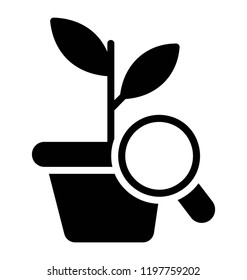 Magnifier over pot plant depicting botanical research 