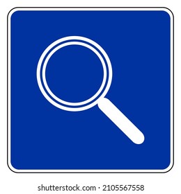 Magnifier and road sign on white