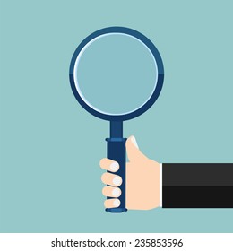 Magnifying glass in a hand