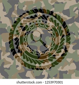 magnifying glass icon inside camouflage emblem