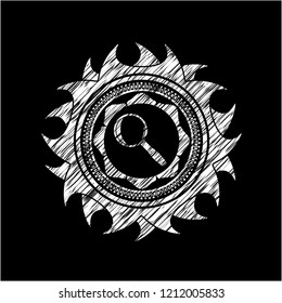 magnifying glass icon inside chalkboard emblem