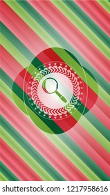 magnifying glass icon inside christmas colors badge.