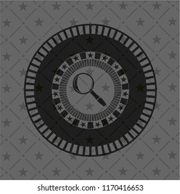 magnifying glass icon inside dark badge or emblem
