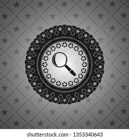 magnifying glass icon inside dark badge or emblem