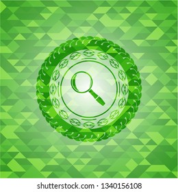 magnifying glass icon inside green emblem with triangle mosaic background