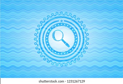 magnifying glass icon inside light blue water wave emblem.