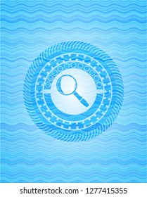 magnifying glass icon inside light blue water style badge.