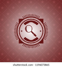 magnifying glass icon inside red icon or emblem