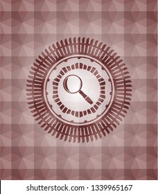 magnifying glass icon inside red seamless emblem with geometric pattern.