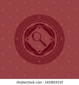 magnifying glass icon inside red emblem