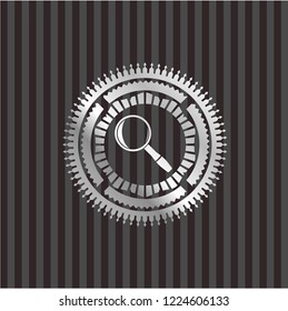 magnifying glass icon inside silver shiny badge
