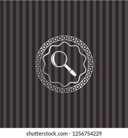 magnifying glass icon inside silver emblem