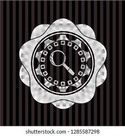 magnifying glass icon inside silver shiny emblem