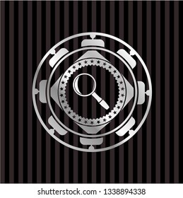 magnifying glass icon inside silver badge or emblem