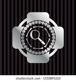 magnifying glass icon inside silver shiny badge